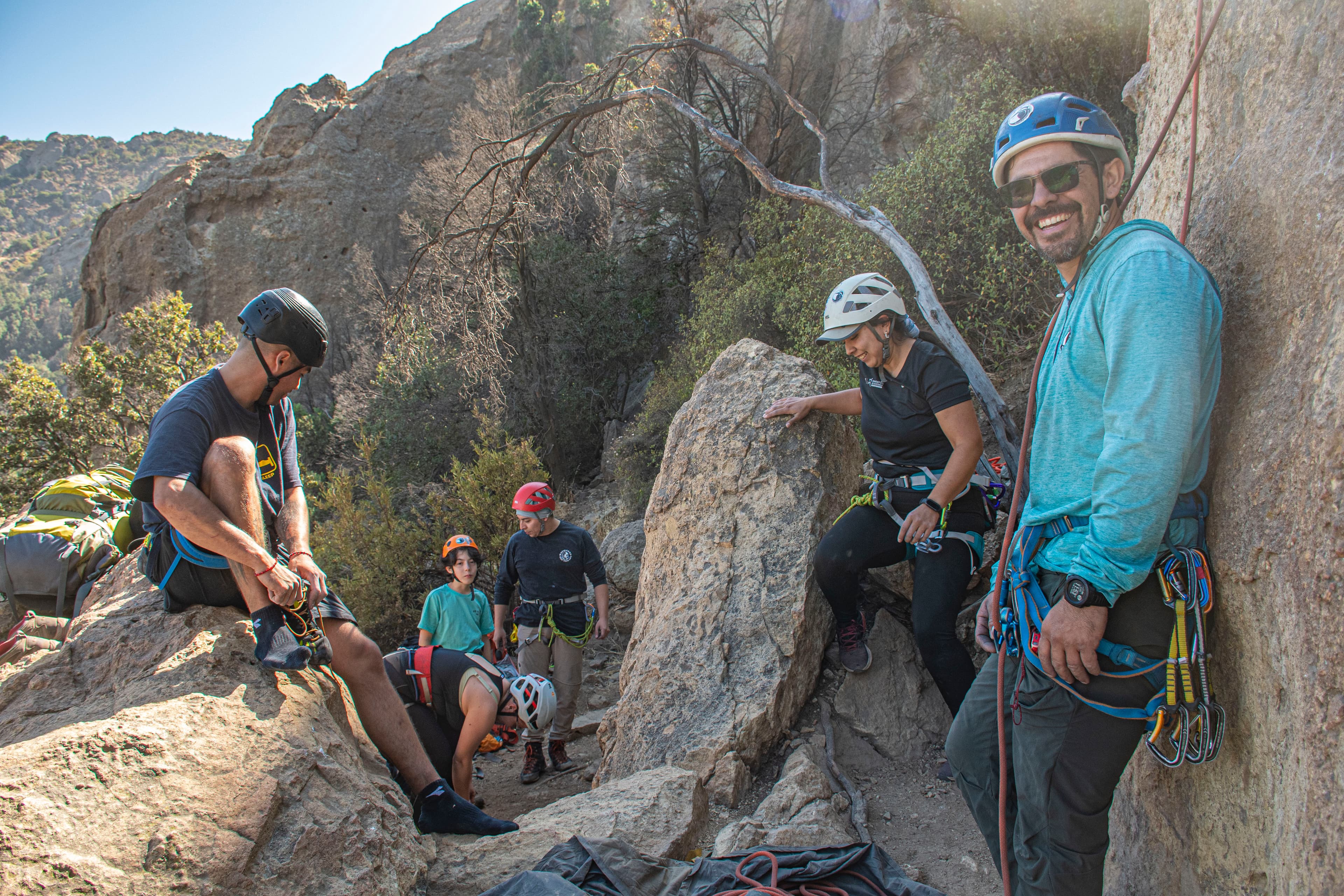 A group of climbers preparing beside a rock wall during the Pucón retreat.