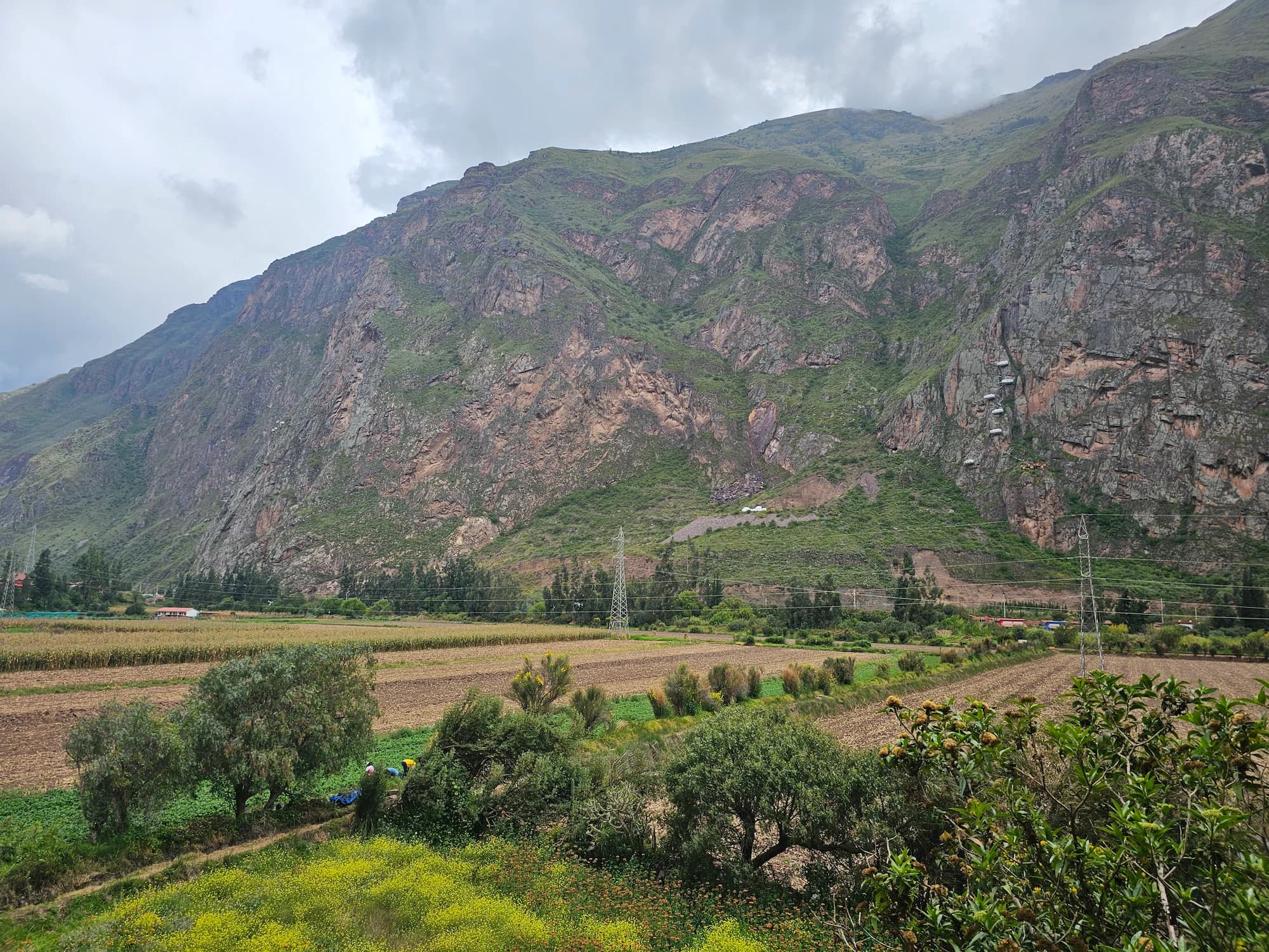 A rock climber on a steep limestone wall in the Peruvian Andes.